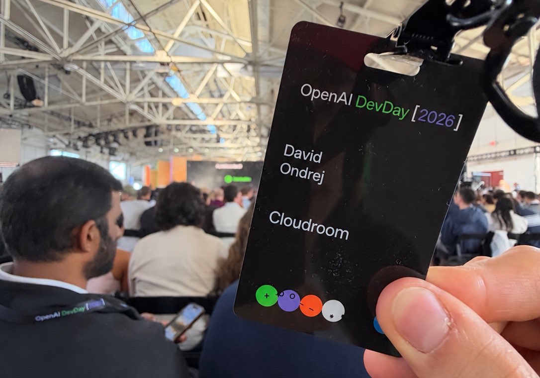 David Ondrej holding his OpenAI DevDay 2026 badge in the keynote hall.